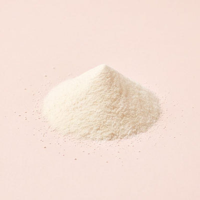 A pile of ivory probiotic powder on blush-oat