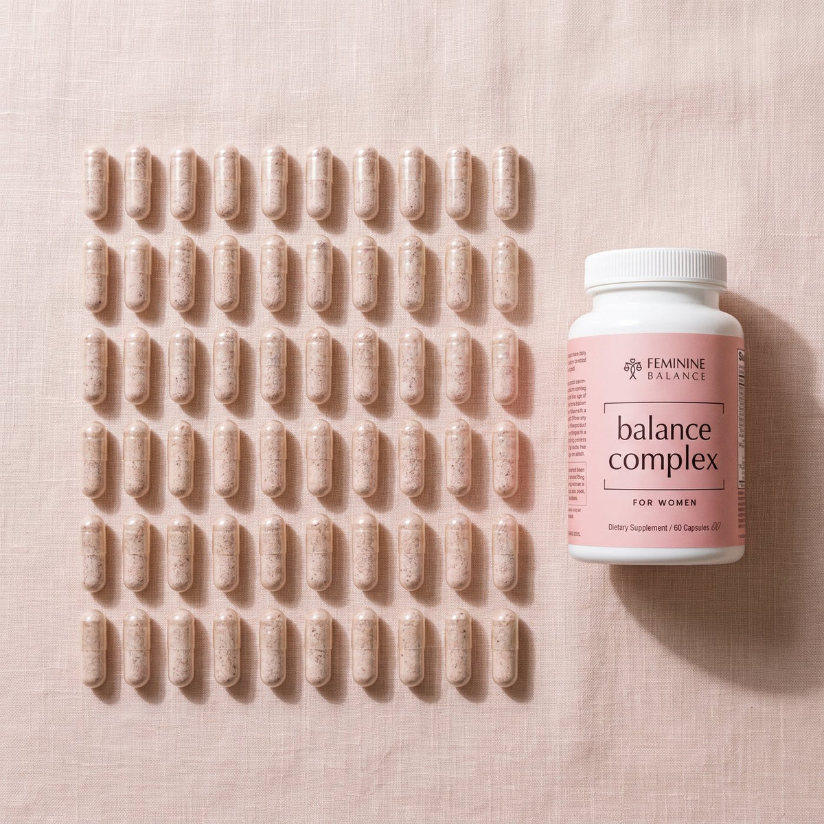 Overhead: the bottle beside 60 capsules laid out in a 10 by 6 grid, a month of two-a-day