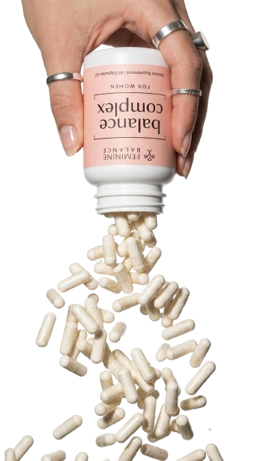 Hand pouring Balance Complex capsules from the bottle